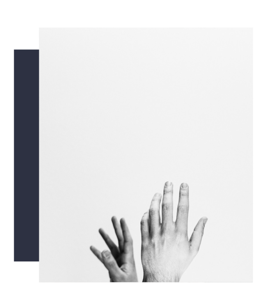 Two palms with the fingers pointing loosely upwards, one turned to the left and the other with the back of the palm facing us are in the centre and bottom of a black and white photograph against a neutral background